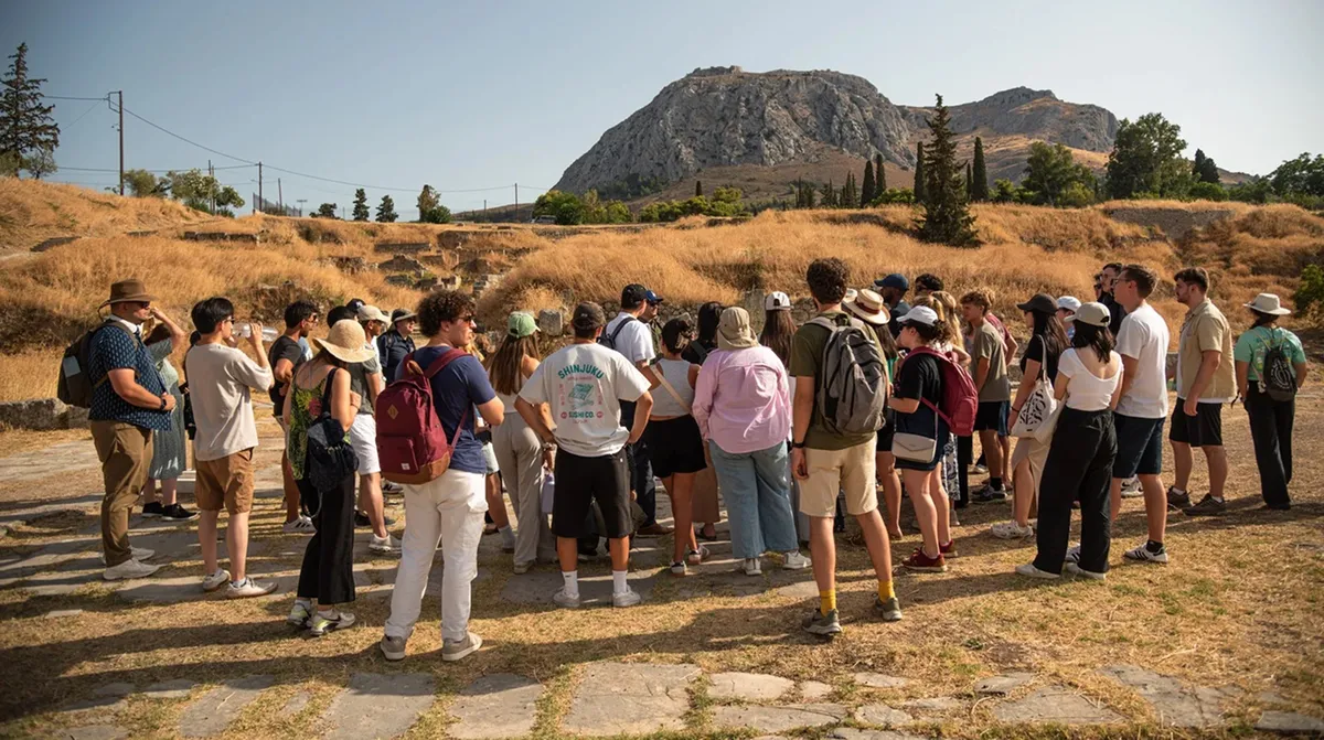 Students among ancient stone ruins in Greece