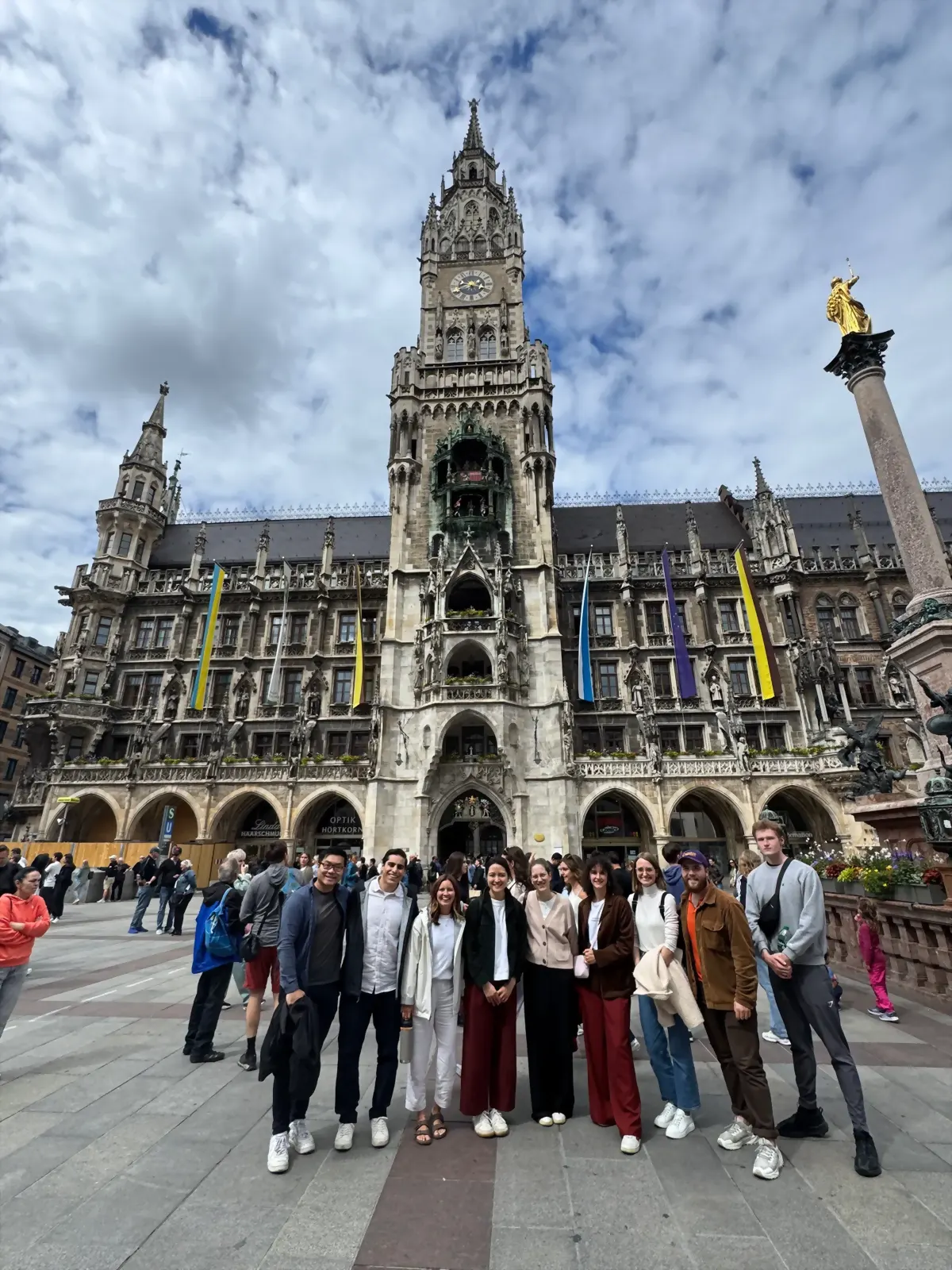 Students in a city square before a gothic town hall