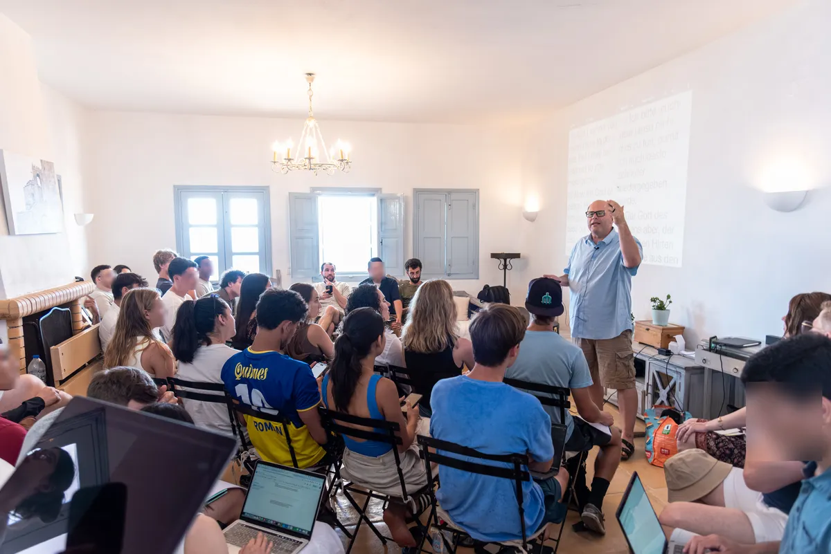 A teaching session, students seated around the room