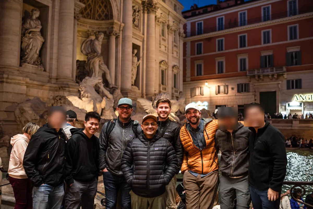 Students together at the Trevi Fountain in Rome at night
