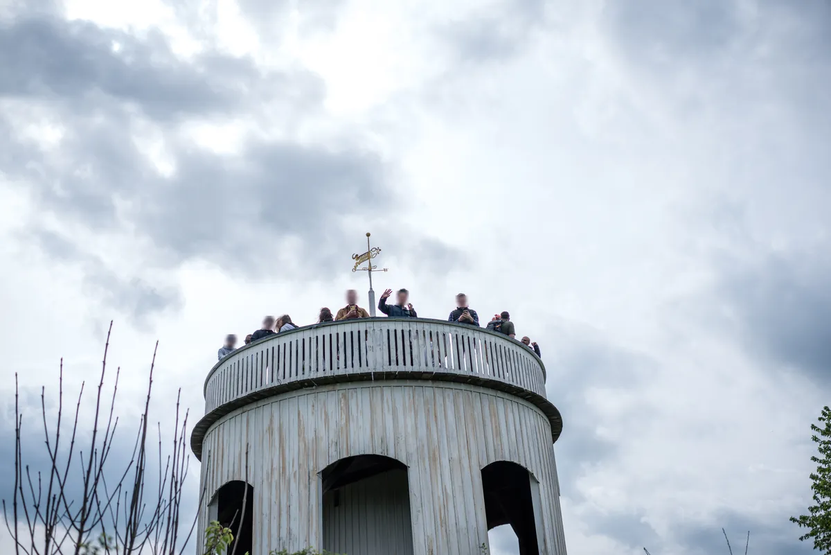 Students on the viewing platform of a hilltop tower